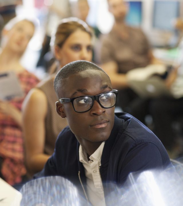 University student listening to IT seminar, students sitting in background